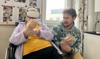 The photo of PhD student Krzysztof Popielski with one of the patients testing the application, wearing VR goggles