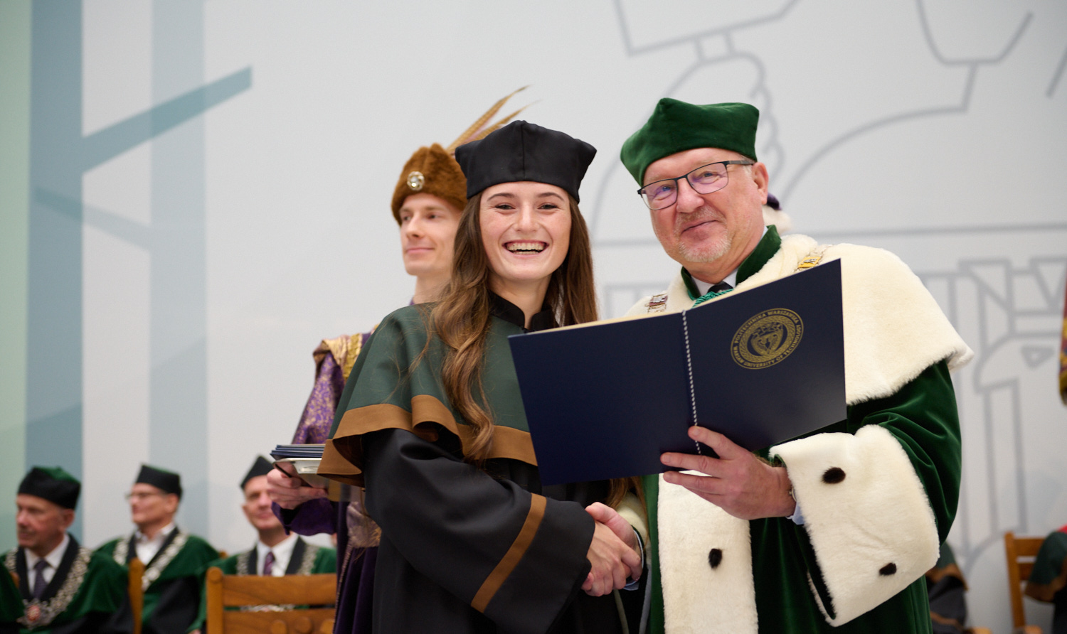 Photo of the WUT Rector and a newly admitted student