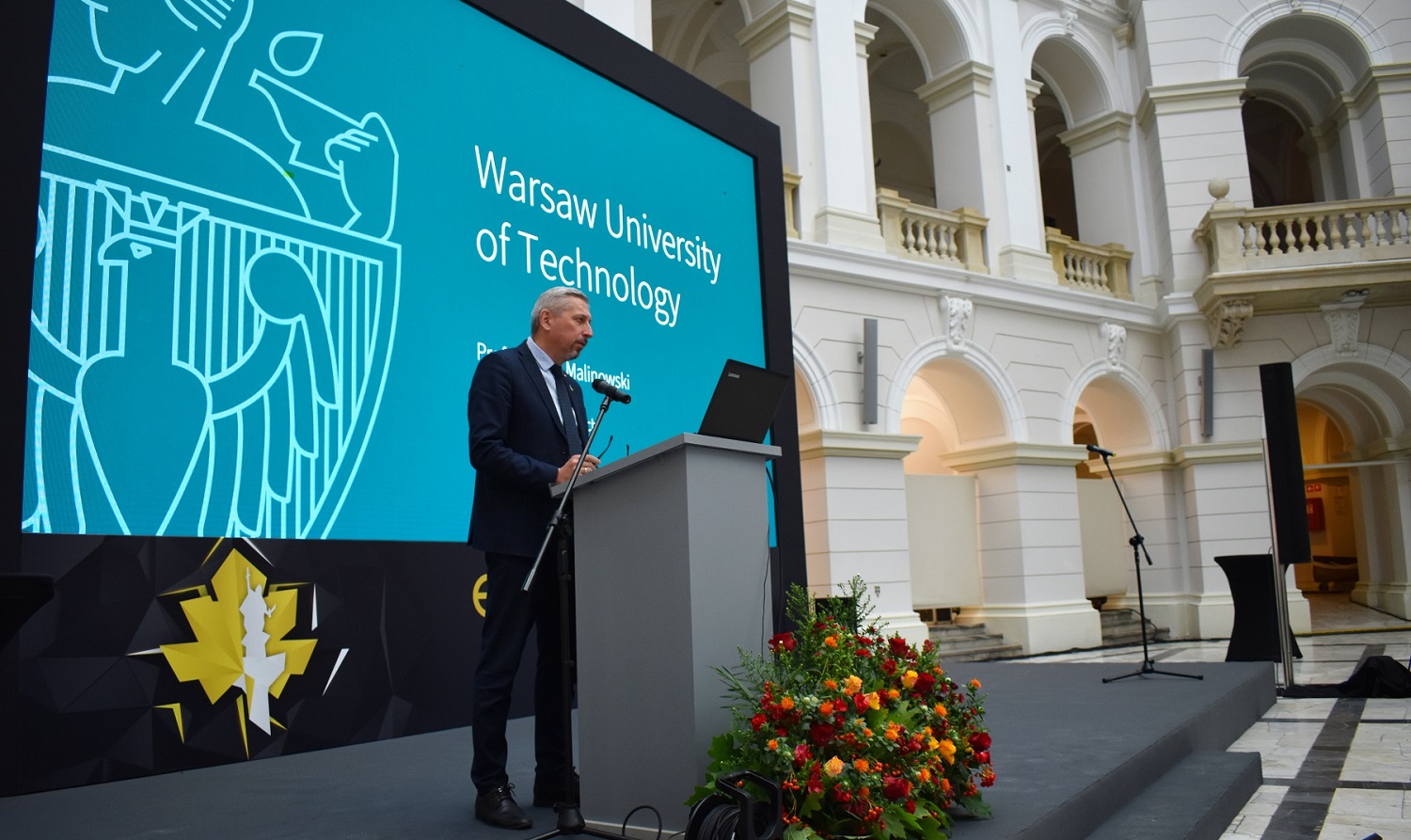 Prof. Mariusz Malinowski on stage  while giving a speech at the conference