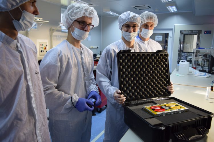 Members of the PW-Sat2 team (Piotr Kuligowski, Dominik Roszkowski, Mateusz Sobiecki, Maciej Kania) are securing the satellite in a special case before bringing it out from the cleanroom. Photo: Michał Gumiela/PW-Sat2/Astronautic Student Research Group