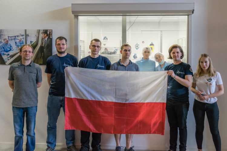 PW-Sat2 Team members after successful QuadPack integration. Left to right: Tomasz Martyniak (Future Processing), Maciej Nowak (Future Processing), Łukasz Żak (Future Processing), Mateusz Sobiecki, Piotr Kuligowski, Inna Uwarowa, Michał Gumiela, Alicja Kasjanowicz.