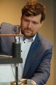 Photo of Arkadiusz Szczęśniak, PhD, at the developed MCFC stack