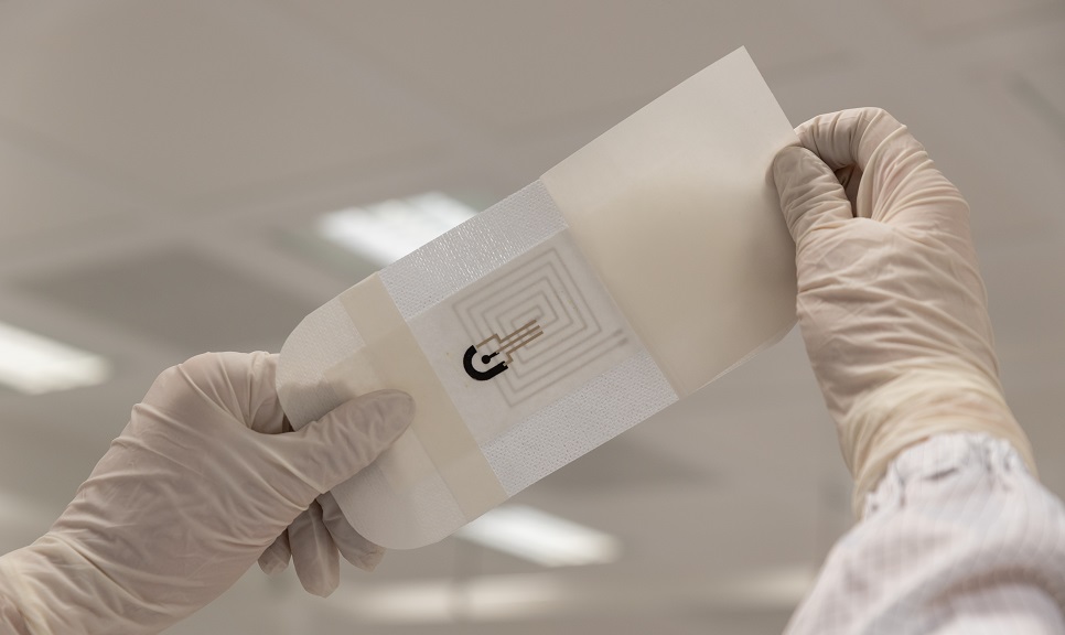 Photo of hands with medical gloves holding a SmartHEAL dressing