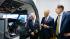 A photo of Pilot Captain Jacek Mainka, Dr Maciej Zasuwa and Ambassador Mark Brzezinski who are standing by the new simulator