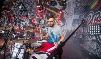 Photo of Dr Mateusz Modrzejewski playing the drums