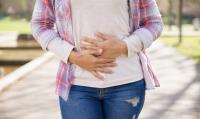 Photo of the woman holding her stomach