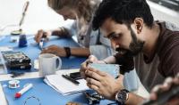 Photo of electrical technicians working on electronic parts