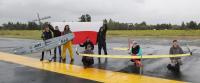 In the photo, the SAE AeroDesign team along with the airplanes is depicted